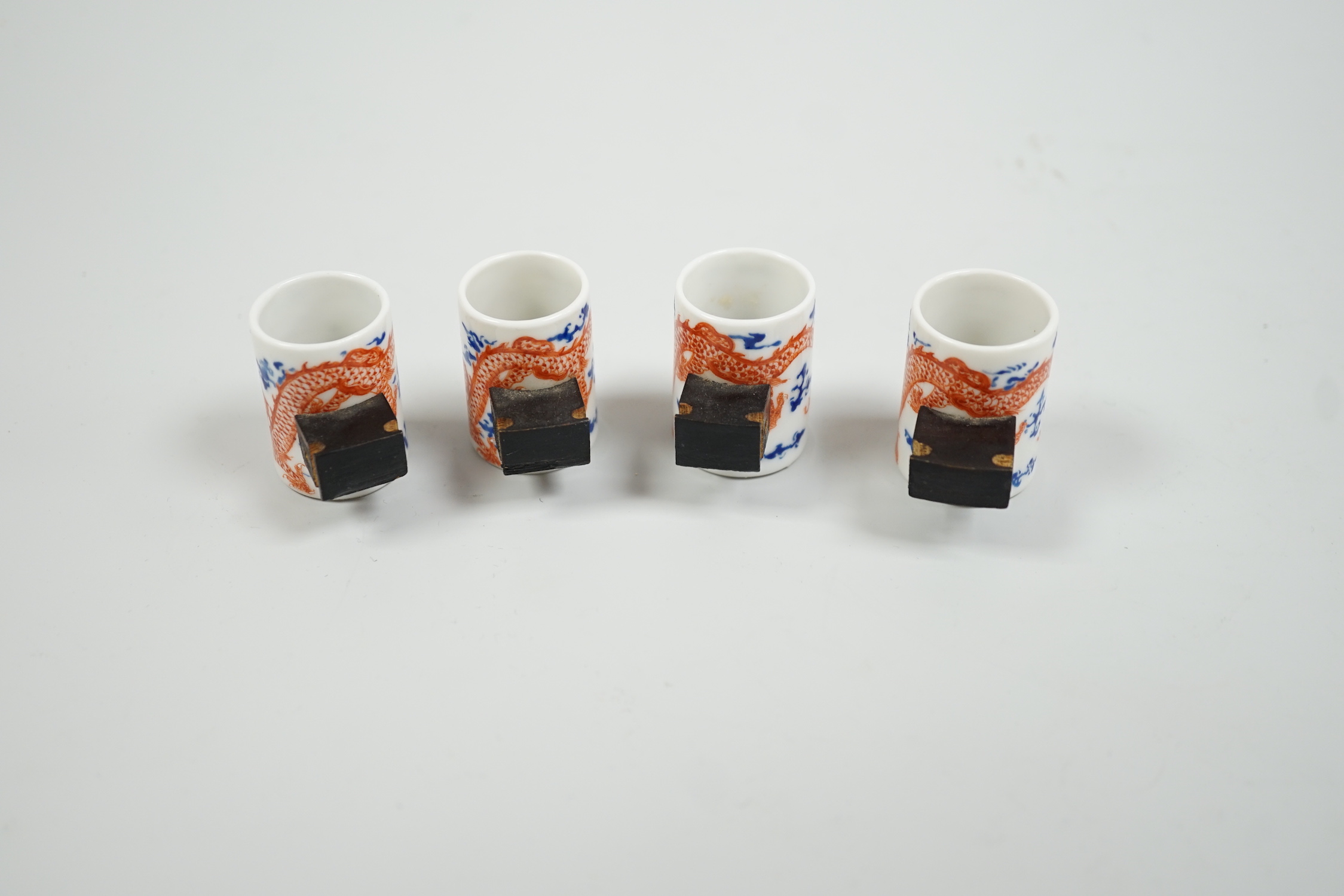 A set of four Chinese enamelled porcelain 'dragon' bird feeders, late 19th / early 20th century, 3.5cm high